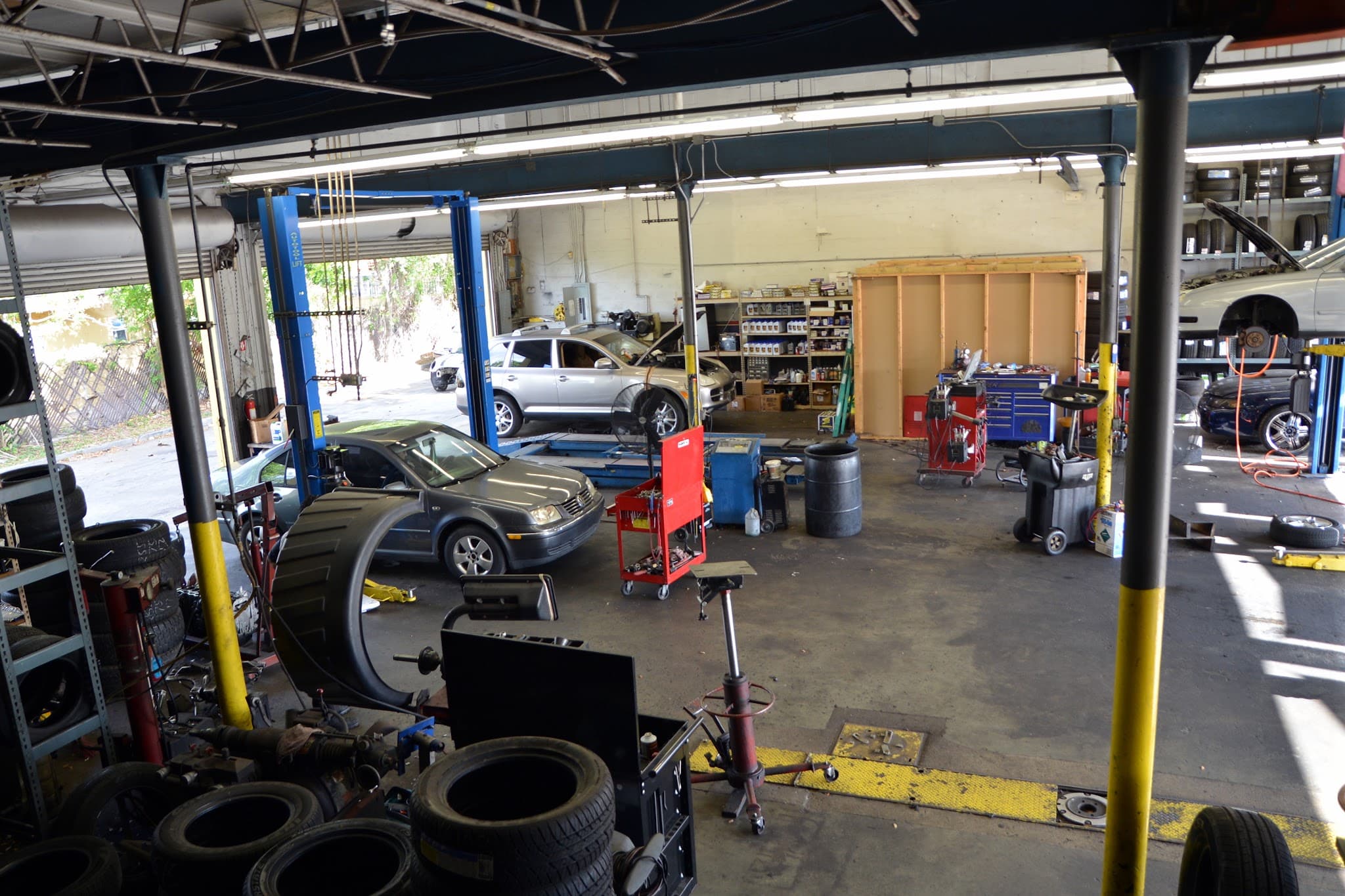 Cars on the lifts in the 4 service bays at Marka Tires & Auto Repair