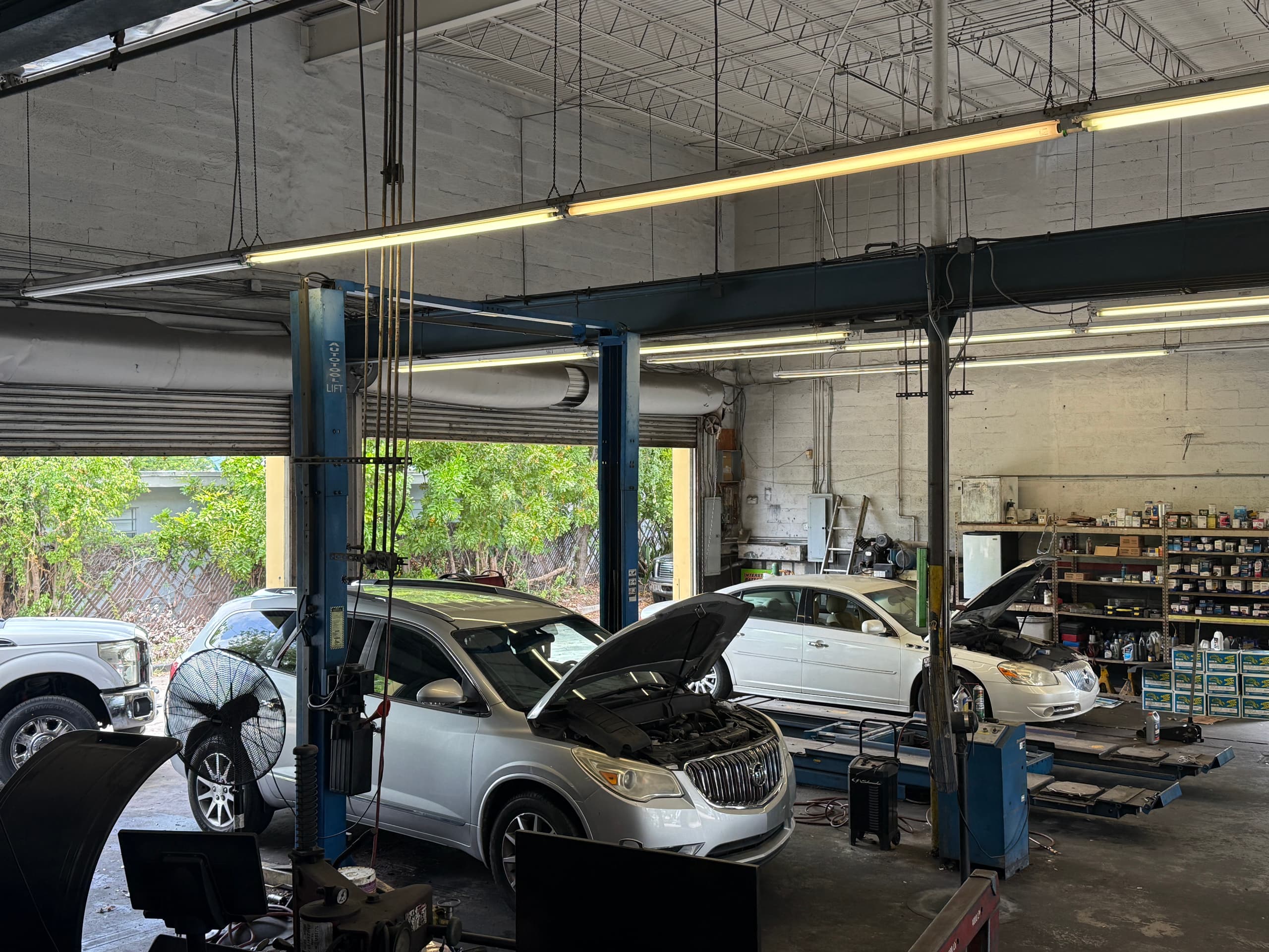 The service bays at Marka Tires & Auto Repair with hoods raised