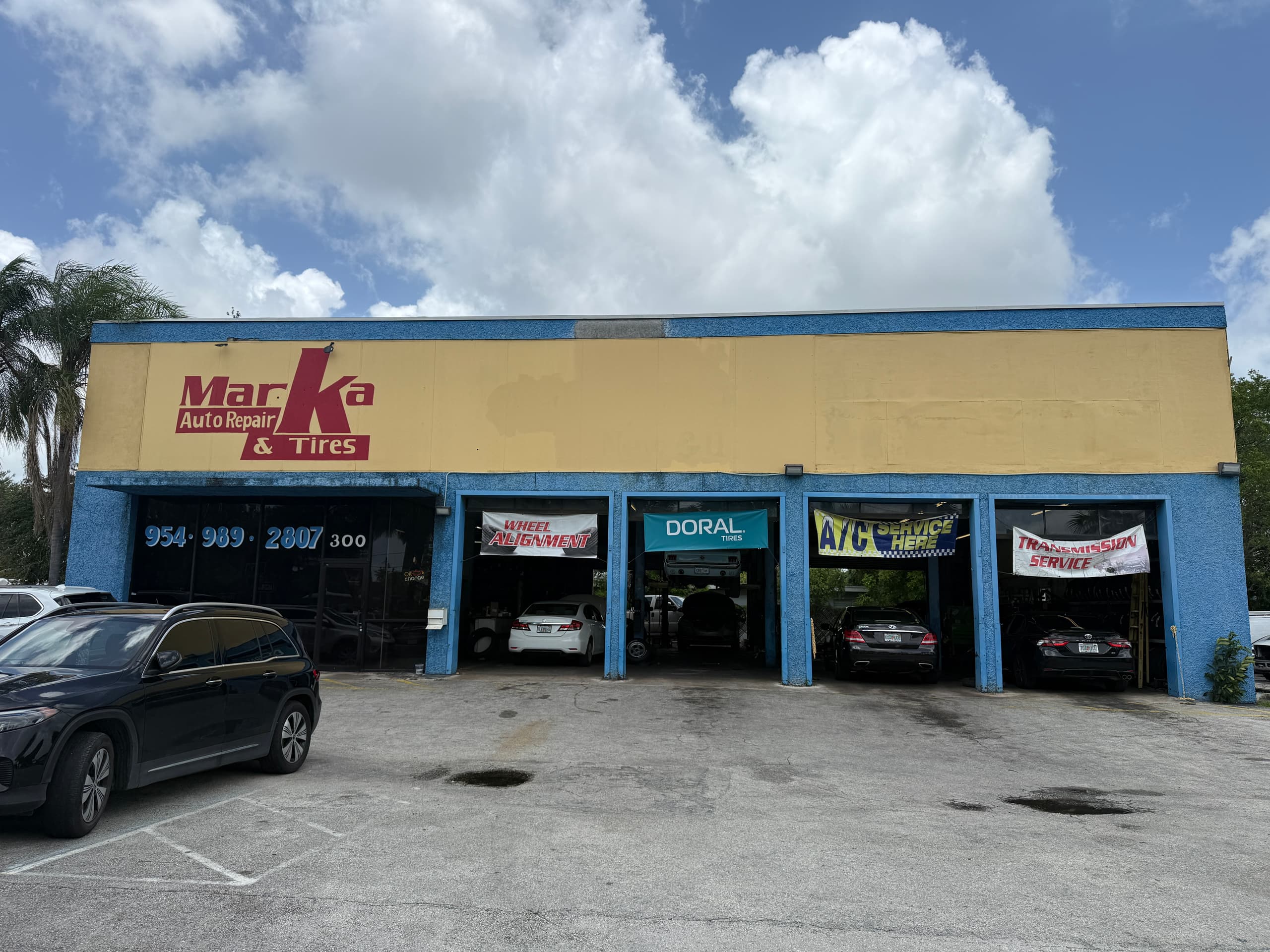 A/C service banner over the four bays at Marka